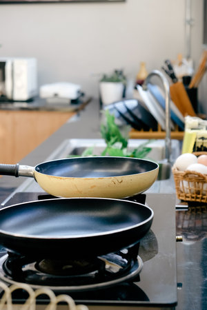 Frying pan on the stove in a modern kitchen.の写真素材