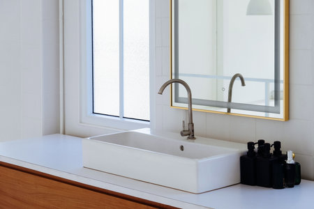 modern bathroom with white sink, faucet and mirror, interior designの写真素材