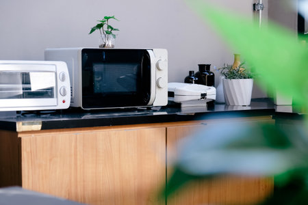 Microwave oven on the table in the kitchen at home.の写真素材