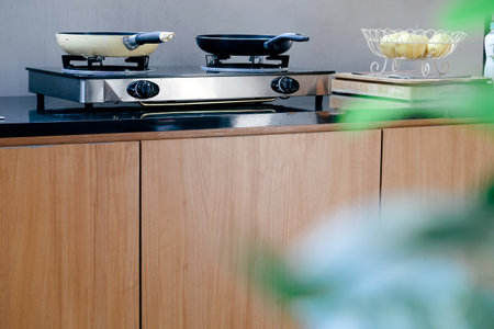 Frying pan on the stove in a modern kitchen.の写真素材
