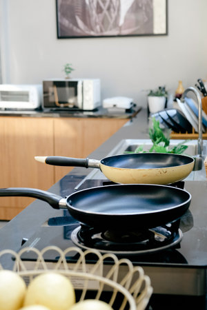 Frying pan on the stove in a modern kitchen.の写真素材