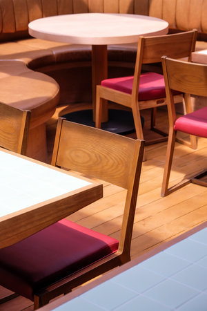 Wooden chairs and tables in a cafe, closeup of photoの写真素材