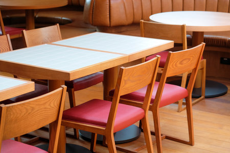 Wooden chairs and tables in a cafe, closeup of photoの写真素材