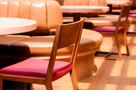 Wooden chairs and tables in a cafe, closeup of photo