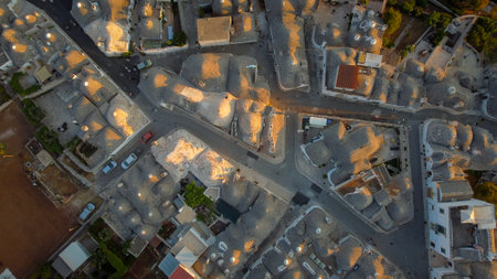 Aerial view of characteristic trulli houses at sunset in Alberobello, tourist town in Puglia, Italyの写真素材