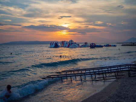 Sunset in Croatia coast in Makarska beach in Dalmatian coast. Magnificent view of the sun and evening colorsの写真素材