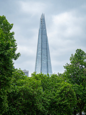 View of The Shard skyscraper in central London in the Southwark district south of the River Thames. Designed by Italian architect Renzo Piano. Building in the background with treesの写真素材