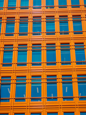 Abstract urban view of orange building facade with windows. building exterior of Saint Giles buildings in the streets of London cityの写真素材