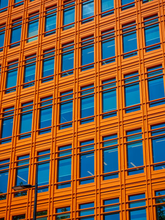 Abstract urban view of orange building facade with windows. building exterior of Saint Giles...