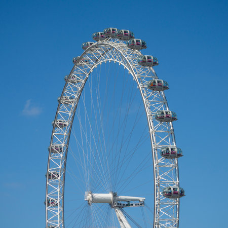 Abstract minimalist view of the London Eye, the tallest Ferris wheel in Europe with a clear blue sky background. Urban photography Londonの写真素材