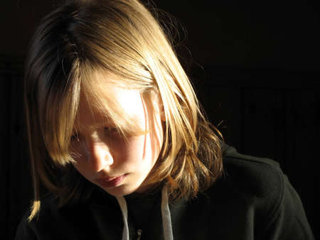 Girl thinking or reading, could be sad or just focusedの写真素材