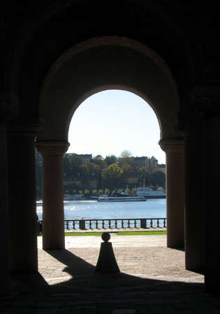 Arch and pillars at an entrance to a giant beautiful buildingの写真素材