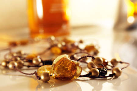 Amber heart on necklace with golden pearlsの写真素材