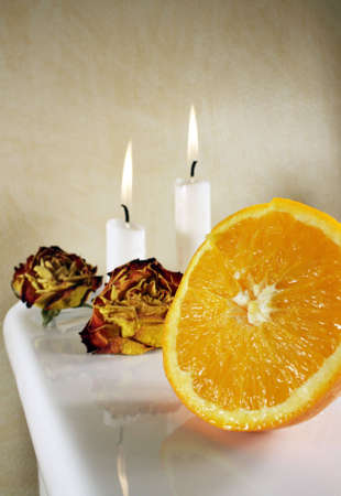 Fresh orange with roses and candlelights for some の写真素材