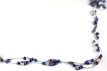 Blue necklace with stones and pearls as frame with white message areaの写真素材