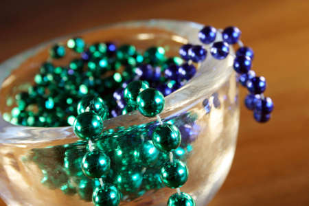 Necklace with green and blue pearls in a bowlの写真素材