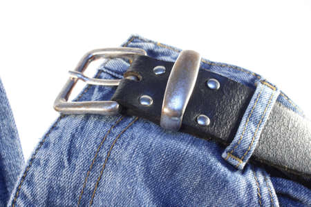 Pair of jeans with black belt isolated on whiteの写真素材
