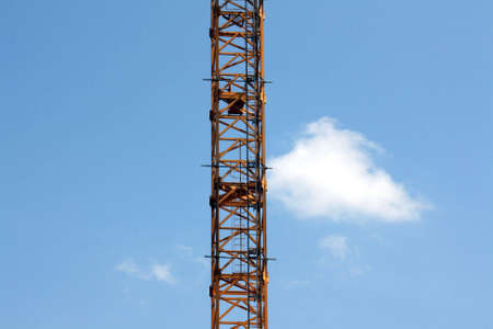 Construction crane with blue sky and cloudの写真素材