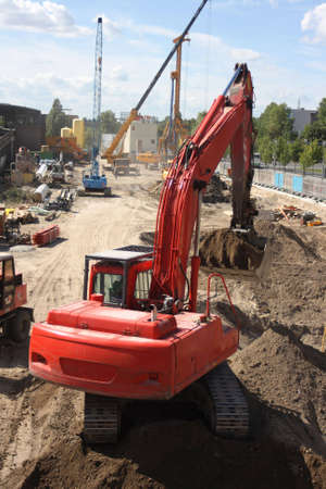 Excavator on construction site digging up dirtの写真素材