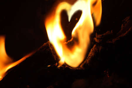 Fire burning in the shape of a heartの写真素材