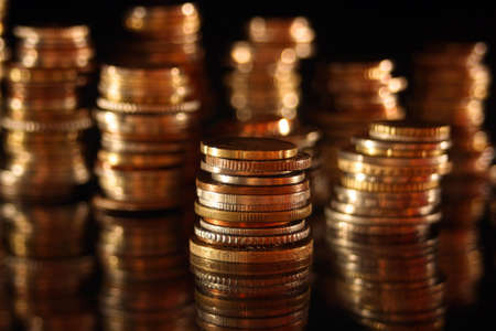 Money in piles of golden coinsの写真素材