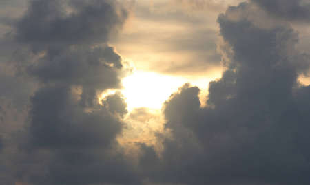 Sun through the clouds in an openingの写真素材