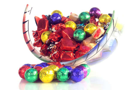 Christmas sweets in a glass bowl with reflection on whiteの写真素材