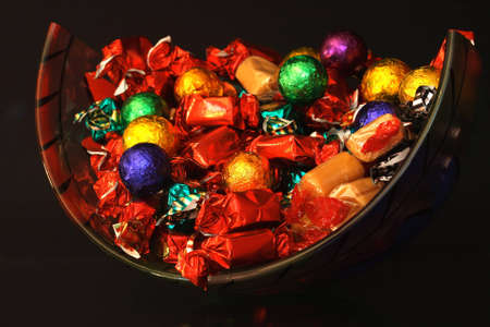 Sweets in a glass bowl with black backgroundの写真素材