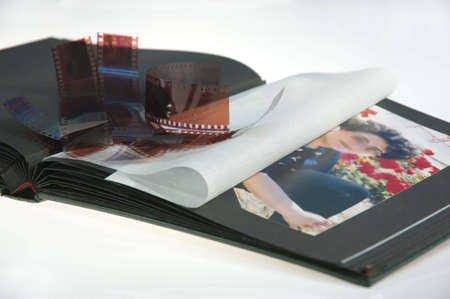 old album and filmstrip on white background