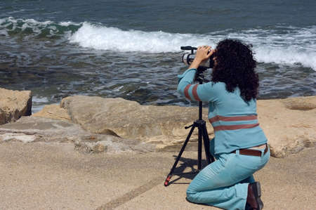 camerawoman on backround of the seaの写真素材