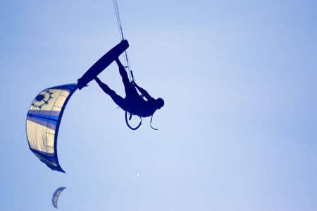 kitesurfing, silhouette of sportmen on blueの写真素材