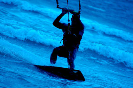 kite surfing, silhouette of sportsmen on blueの写真素材