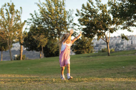 Portrait of cute young girl running on lawnの写真素材