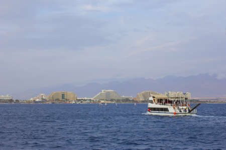 Pleasure-boat on background of Eilat, Red Sea