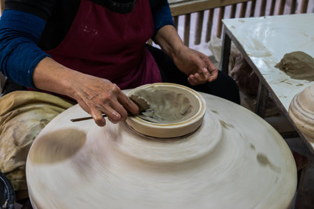 Hands working on pottery wheelの写真素材