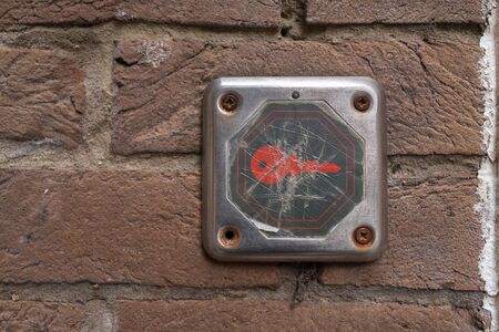 Damaged Key Sign on Brick Wallの写真素材