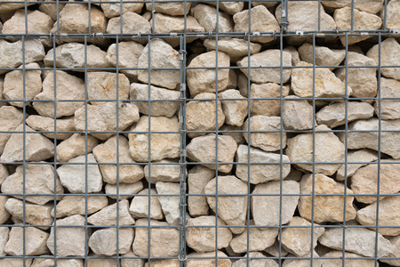 A Metal Fence Grid over Rock backgroundの写真素材