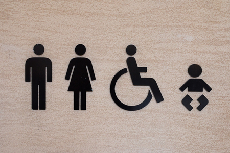 Black Toilet Icon on Delicate Cream Color Sand Stone Wallの写真素材