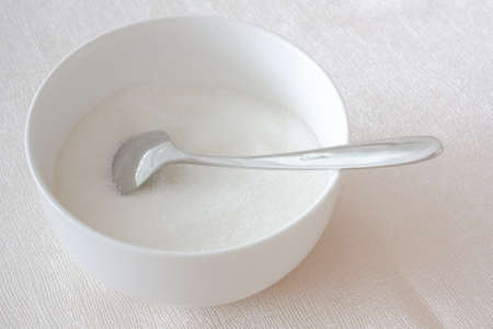 bowl of sugar with stainless spoonの写真素材