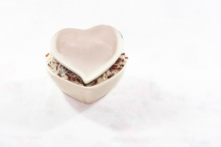 Ceramic cup rice in a heart shape.の写真素材