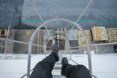 The technician is sitting at the top of the fire escape stairs.の写真素材