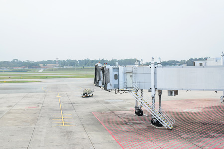 Jet bridge from an airport terminal gate at Singapore.の写真素材