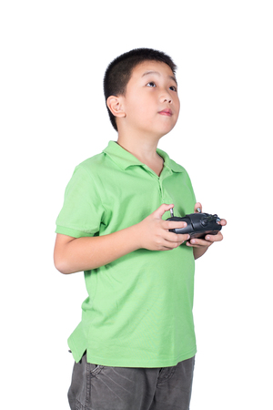 Little boy holding a radio remote control (controlling handset) for helicopter , drone or plane Isolated on white backgroundの写真素材