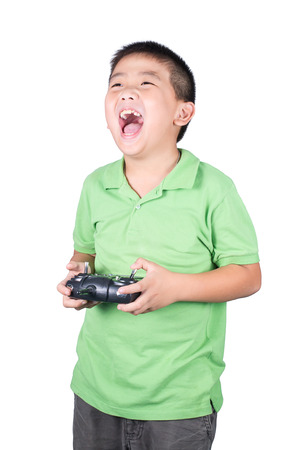 Little boy holding a radio remote control (controlling handset) for helicopter , drone or plane Isolated on white backgroundの写真素材