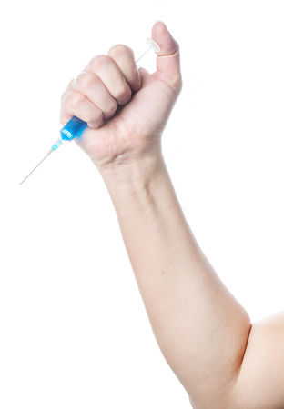 syringe in a hand on white background, isolatedの写真素材