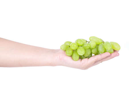 Man hand holding a bunch of green grapes, Isolated on white background.の写真素材
