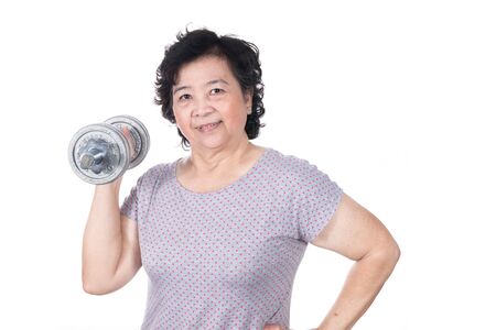 Asian strong senior woman lifting weights, isolated on white background.の写真素材