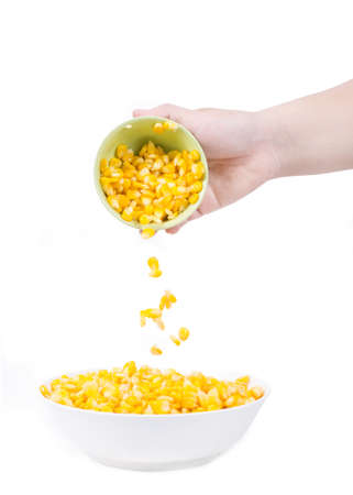Sweet corn in white bowl ready for eat with hand and spoon.の写真素材