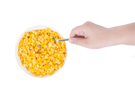 Sweet corn in white bowl ready for eat with hand and spoon.の写真素材