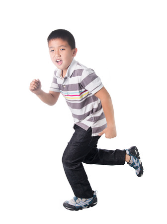 Asian boy running, isolated on white background.の写真素材